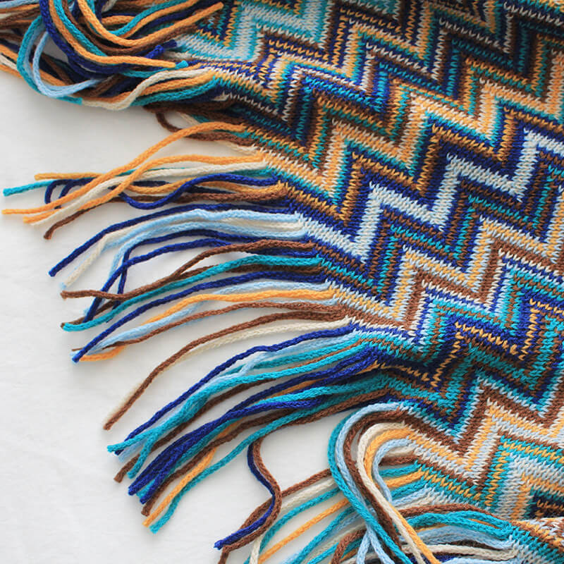 Colorful striped throw blanket with tassels